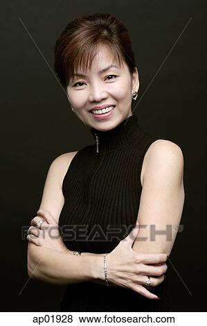 Woman with arms crossed, smiling, portrait View Large Photo Image Stock Photo - Woman with arms crossed, smiling, portrait. Fotosearch