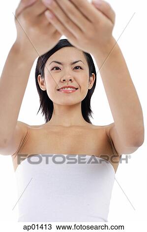 Woman with arms outstretched, low angle view View Large Photo Image Stock Image - Woman with arms outstretched, low angle view. Fotosearch