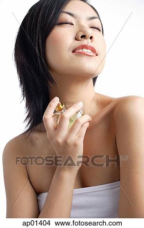 Woman with perfume bottle, eyes closed View Large Photo Image Picture - Woman with perfume bottle, eyes closed. Fotosearch