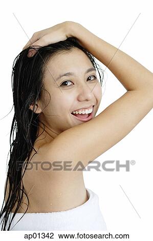 Woman with wet hair, wrapped in a towel, looking over shoulder, hand on head View Large Photo Image Stock Image - Woman with wet hair, wrapped in a towel, looking over shoulder, hand on head. Fotosearch