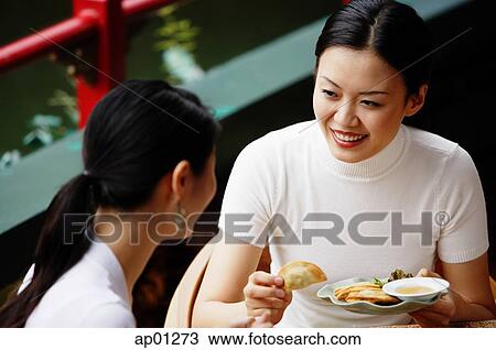 Women in cafe, eating View Large Photo Image Stock Image - Women in cafe, eating. Fotosearch