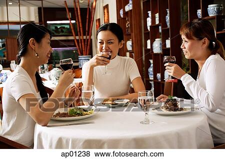 Women in restaurant, eating View Large Photo Image Stock Photo - Women in restaurant, eating. Fotosearch