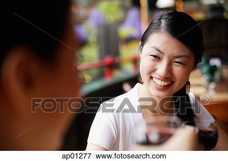 Women smiling at person in front of her View Large Photo Image Stock Photo - Women smiling at person in front of her. Fotosearch