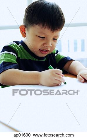 Stock Image - Young boy drawing. Fotosearch