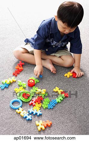 Young boy playing with building block toys View Large Photo Image Picture - Young boy playing with building block toys. Fotosearch