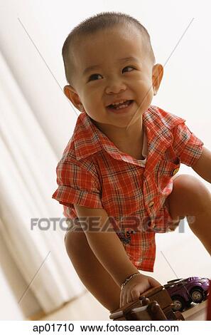 Young boy trying to stand, smiling View Large Photo Image Stock Image - Young boy trying to stand, smiling. Fotosearch