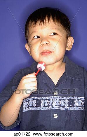 Young boy with lollypop, looking away View Large Photo Image Stock Image - Young boy with lollypop, looking away. Fotosearch