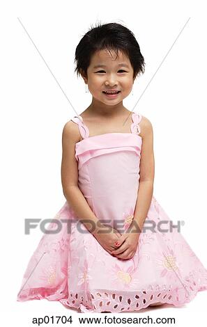 Young girl in pink dress, looking at camera View Large Photo Image Picture - Young girl in pink dress, looking at camera. Fotosearch