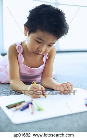 Young girl lying on floor, drawing View Large Photo Image Stock Image - Young girl lying on floor, drawing. Fotosearch