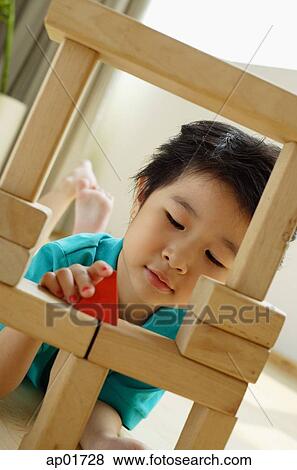 Young girl playing with building blocks View Large Photo Image Stock Photo - Young girl playing with building blocks. Fotosearch