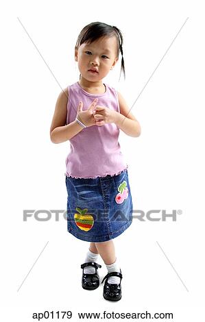 Young girl standing, looking at camera View Large Photo Image Stock Photo - Young girl standing, looking at camera. Fotosearch