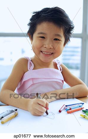 Young girl with crayons, smiling at camera View Large Photo Image Stock Photo - Young girl with crayons, smiling at camera. Fotosearch