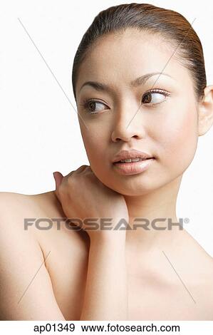 Young woman, hand around neck, looking away View Large Photo Image Stock Photo - Young woman, hand around neck, looking away. Fotosearch