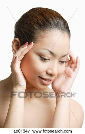 Young woman, hands on head, looking down View Large Photo Image Stock Photo - Young woman, hands on head, looking down. Fotosearch