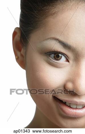 Stock Image - Young woman looking at camera, head shot. Fotosearch