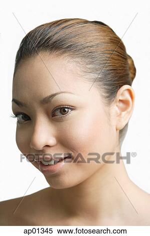 Stock Photography - Young woman looking at camera, portrait. Fotosearch