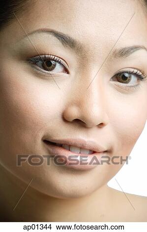 Picture - Young woman looking at camera, smiling. Fotosearch