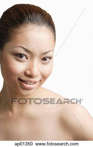 Young woman, looking at camera, smiling View Large Photo Image Stock Image - Young woman, looking at camera, smiling. Fotosearch