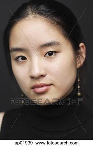 Stock Photo - Young woman looking at camera. Fotosearch