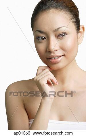 Young woman, looking away, hand on chin View Large Photo Image Stock Image - Young woman, looking away, hand on chin. Fotosearch