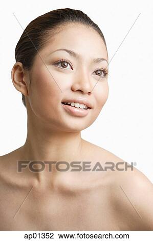 Stock Image - Young woman, looking away, portrait. Fotosearch