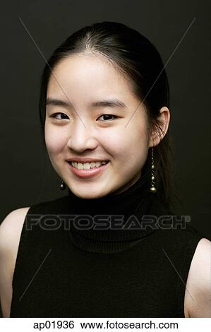 Young woman smiling at camera View Large Photo Image Stock Photograph - Young woman smiling at camera. Fotosearch