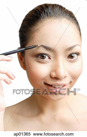 Young woman using eyebrow pencil View Large Photo Image Stock Photography - Young woman using eyebrow pencil. Fotosearch