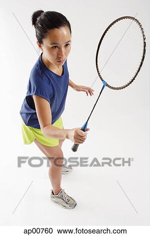 Woman holding badminton racket, high angle view View Large Photo Image Stock Photography - Woman holding badminton racket, high angle view. Fotosearch - Search Stock Photos, Pictures, Wall Murals, Images, and Photo Clipart