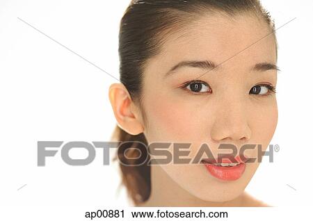 Stock Image - Asian woman looking at camera, head shot. Fotosearch