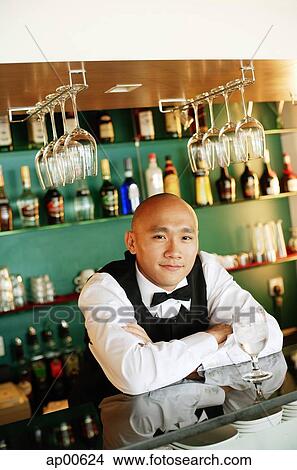 Bartender behind bar counter, arms crossed View Large Photo Image Picture - Bartender behind bar counter, arms crossed. Fotosearch