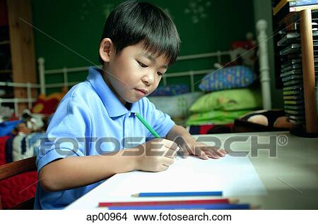 Boy in bedroom, drawing on paper View Large Photo Image Picture - Boy in bedroom, drawing on paper. Fotosearch