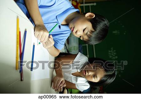 Boy in bedroom, drawing on paper, sister next to him watching View Large Photo Image Stock Photography - Boy in bedroom, drawing on paper, sister next to him watching. Fotosearch