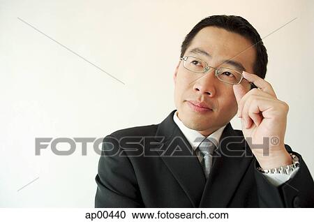 Businessman adjusting glasses View Large Photo Image Stock Image - Businessman adjusting glasses. Fotosearch