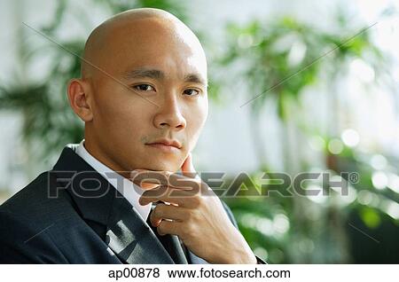 Businessman, hand on chin, looking at camera View Large Photo Image Stock Photo - Businessman, hand on chin, looking at camera. Fotosearch