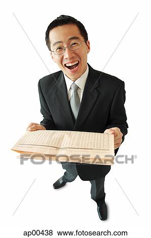 Stock Photo - Businessman holding newspaper, laughing. Fotosearch