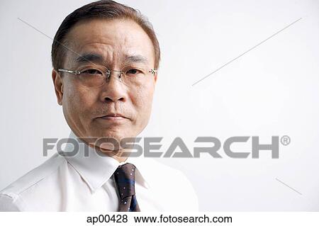 Businessman looking at camera, head shot View Large Photo Image Stock Photo - Businessman looking at camera, head shot. Fotosearch