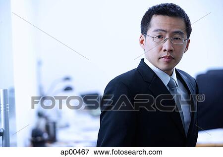 Stock Photo - Businessman looking at camera, portrait. Fotosearch