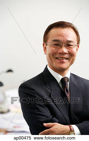 Stock Photography - Businessman looking at camera, portrait. Fotosearch