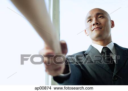 Picture - Businessman shaking hands with someone, low angle view. Fotosearch