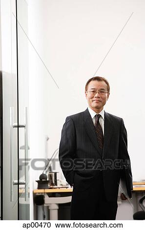 Businessman standing, looking at camera, portrait View Large Photo Image Stock Image - Businessman standing, looking at camera, portrait. Fotosearch