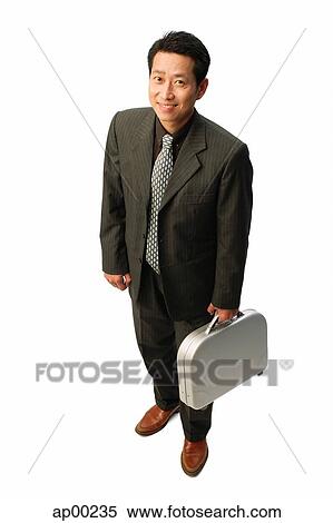 Businessman with briefcase, smiling at camera View Large Photo Image Stock Photography - Businessman with briefcase, smiling at camera. Fotosearch