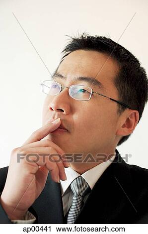 Businessman with hand on chin View Large Photo Image Stock Image - Businessman with hand on chin. Fotosearch