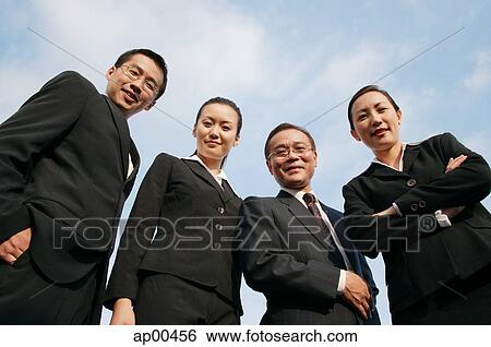 Stock Photograph - Businessmen and businesswomen looking down at camera. Fotosearch