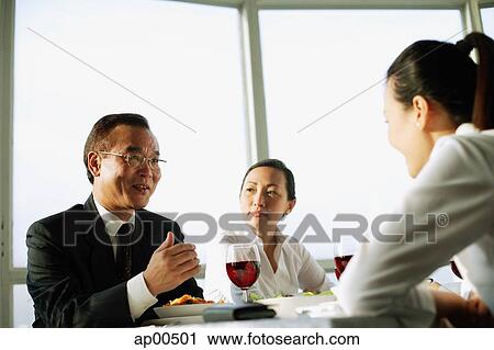 Businesswoman sitting at lunch table, over the shoulder view View Large Photo Image Stock Image - Businesswoman sitting at lunch table, over the shoulder view. Fotosearch