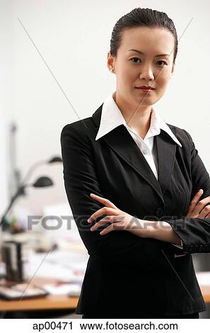 Businesswoman standing with arms crossed View Large Photo Image Stock Image - Businesswoman standing with arms crossed. Fotosearch
