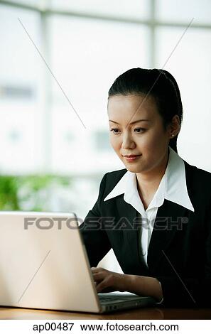 Businesswoman using laptop View Large Photo Image Stock Photo - Businesswoman using laptop. Fotosearch