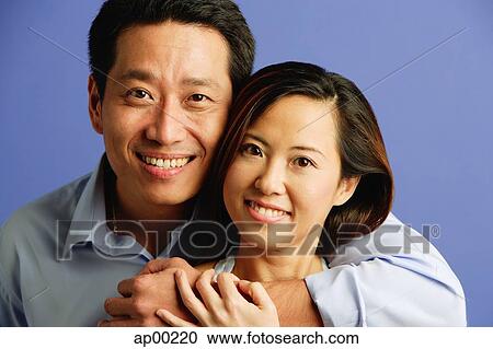 Stock Image - Couple looking at camera, portrait. Fotosearch