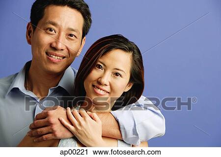 Couple looking at camera, portrait View Large Photo Image Stock Image - Couple looking at camera, portrait. Fotosearch