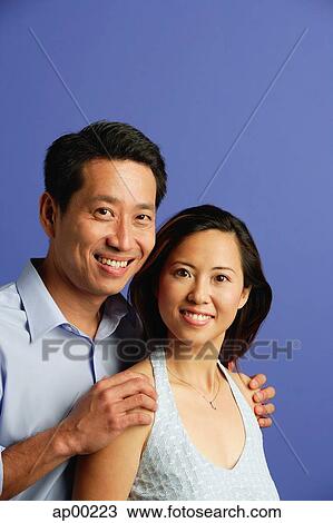 Stock Image - Couple looking at camera, portrait. Fotosearch