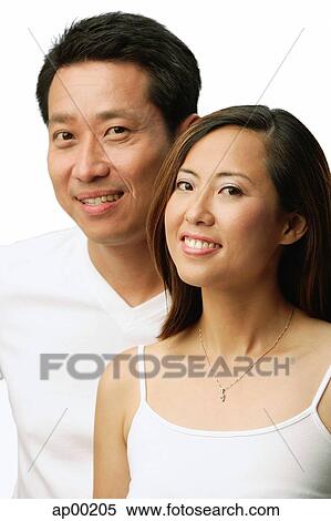 Stock Photography - Couple looking at camera, portrait. Fotosearch